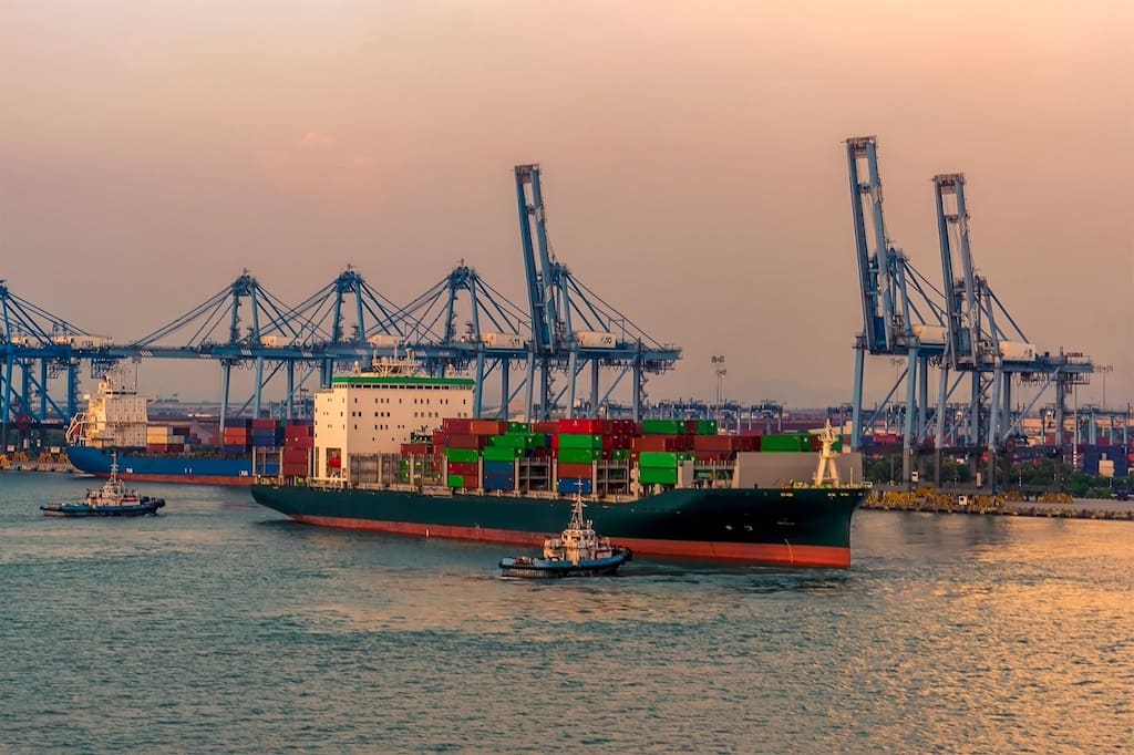 Tug Boats Leading A Vessel In Port